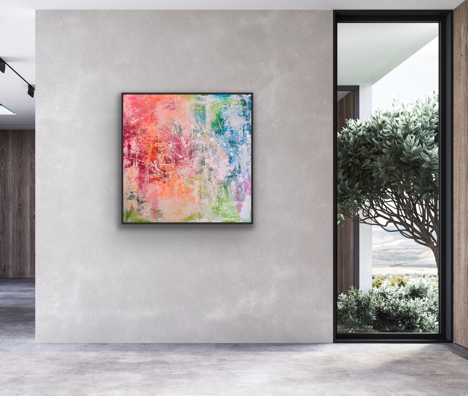 Einrichtungsbeispiel in einem modernen, kühlen Raum mit Betonwänden und großem Fenster: Das farbenfrohe, in warmen Rot- und Orangetönen leuchtende Gemälde 'October' hängt in einem schwarzen Rahmen als zentraler Kontrast an der grauen Wand.